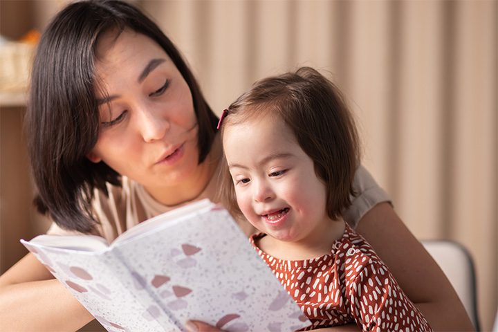 Mom-Reading-to-Little-Girl-with-Down-syndrome